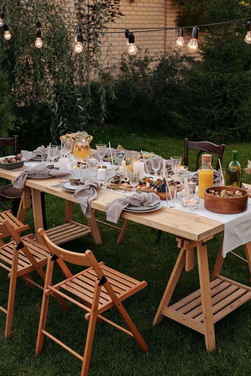 Outdoor dining table with food and drinks on it