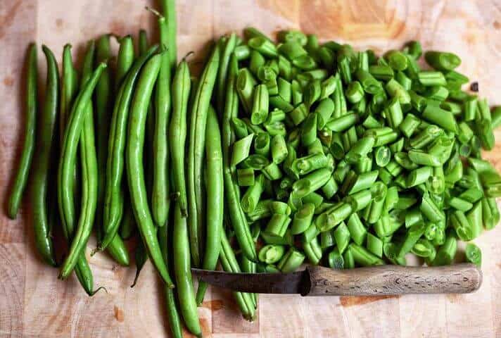 Cut up green beans with a knife