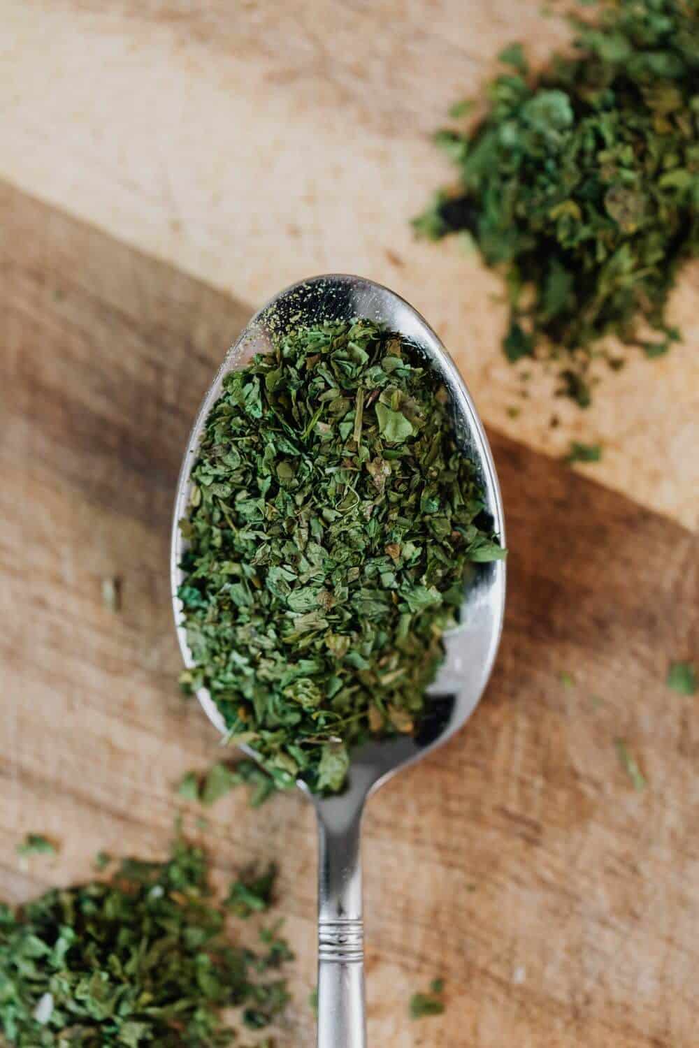 Grinded oregano in a spoon