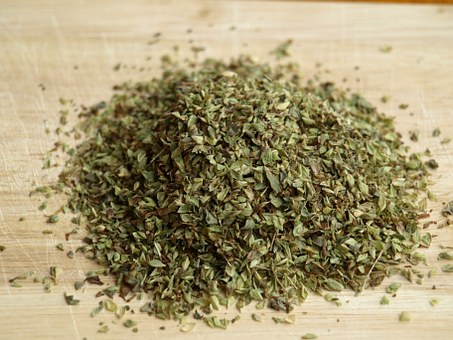 Grinded oregano on a wood board