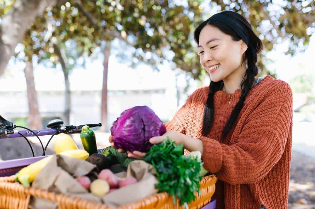 Woman holding purple cabbage